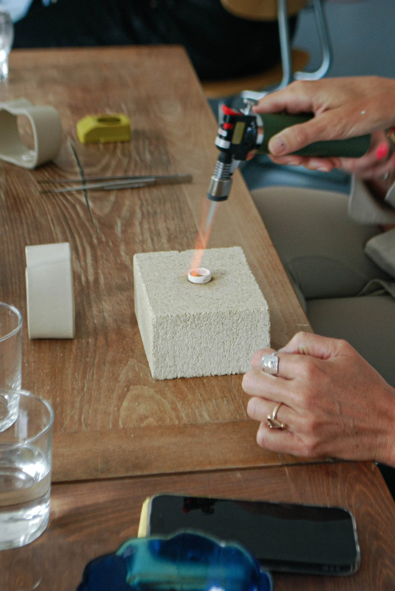 A silver ring held between fingertips